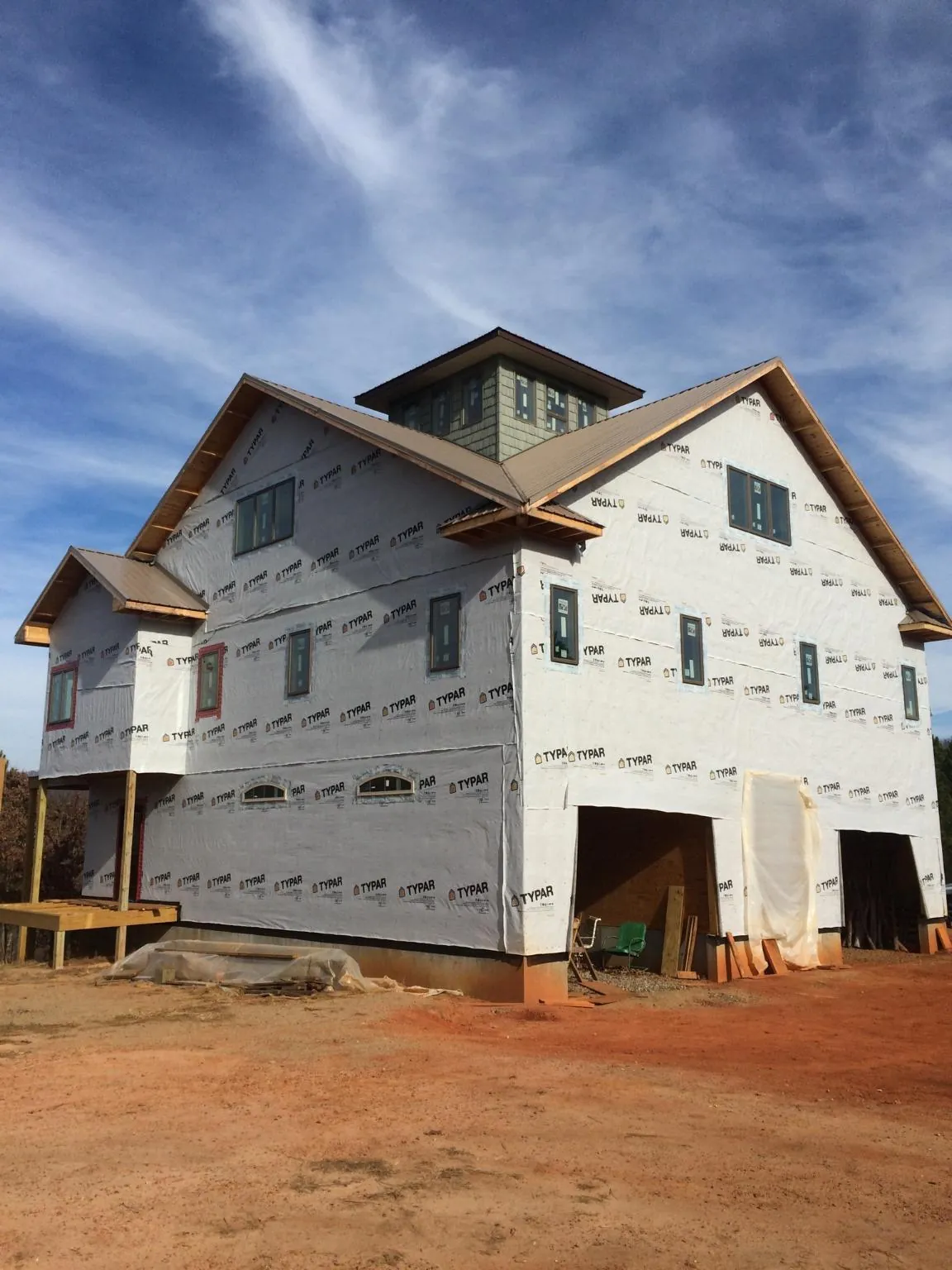 New two story house under construction with a cupola and gabled roofs in Otisville